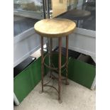 A rustic stool with an oak seat and wrought iron l