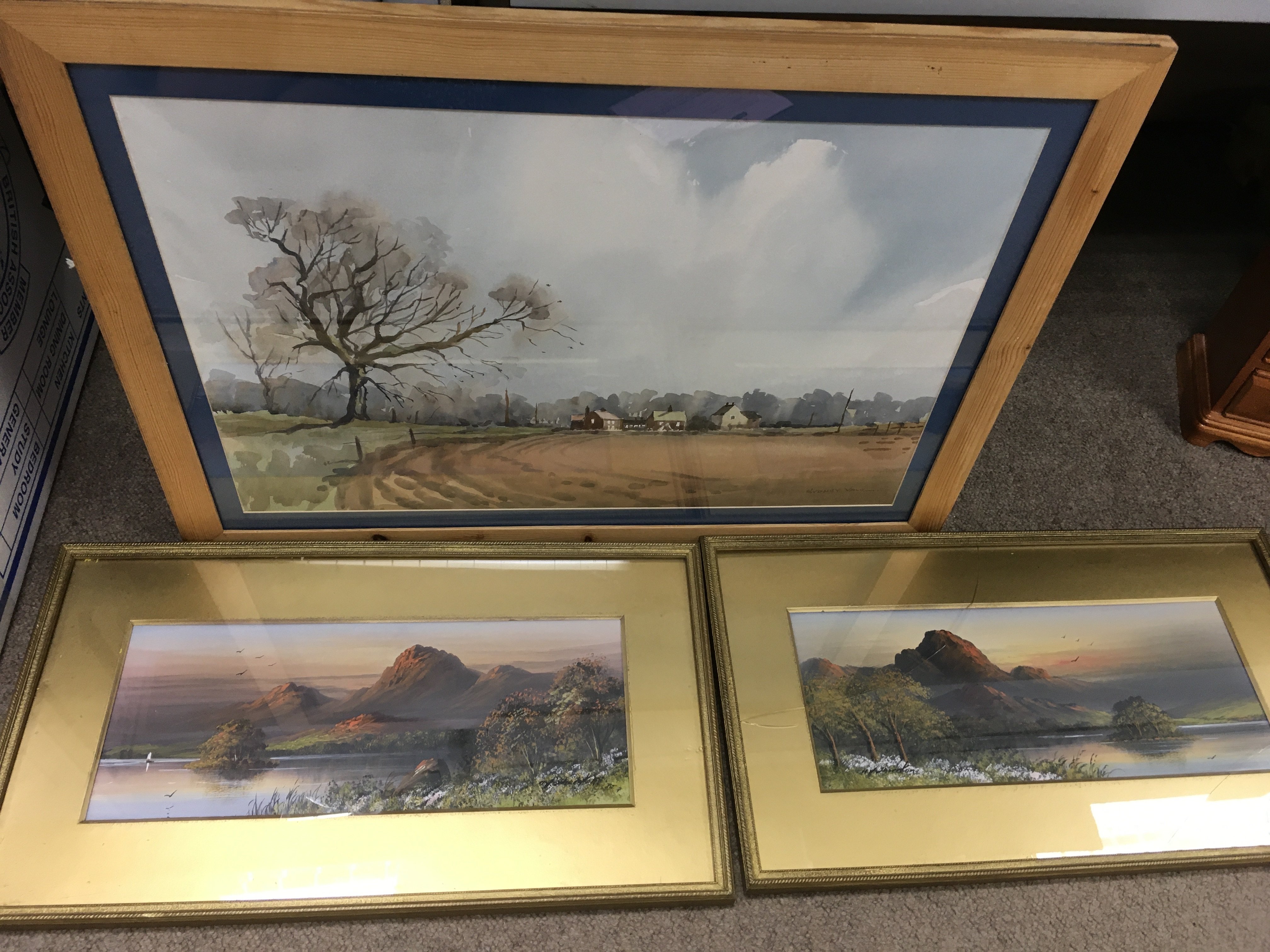 A framed Sydney Vale watercolour and a pair of framed mountainous landscape paintings, one with