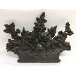 A bronze plaque in the form of a basket of flowers