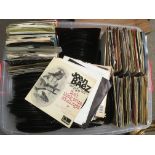 A plastic crate of 7inch singles and EPs by artist