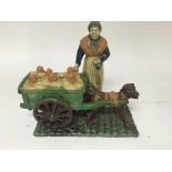 A unusual pottery figure group in the form of a Dutch milk maid with dog Cart . A/F - NO RESERVE