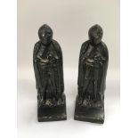 Two cast iron door stops in the form of knights, approx height 20cm.