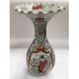 An early 20th Century Japanese vase with a frill top above a baluster body and decorated with