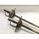Two old rapier style swords with brass handles.