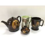 Four Royal Doulton series ware items comprising a teapot (a/f), tankard, jug and vase - NO RESERVE