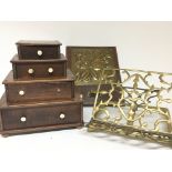 A stepped mahogany flight of drawers a brass book stand and one other brass wall plaque (3)