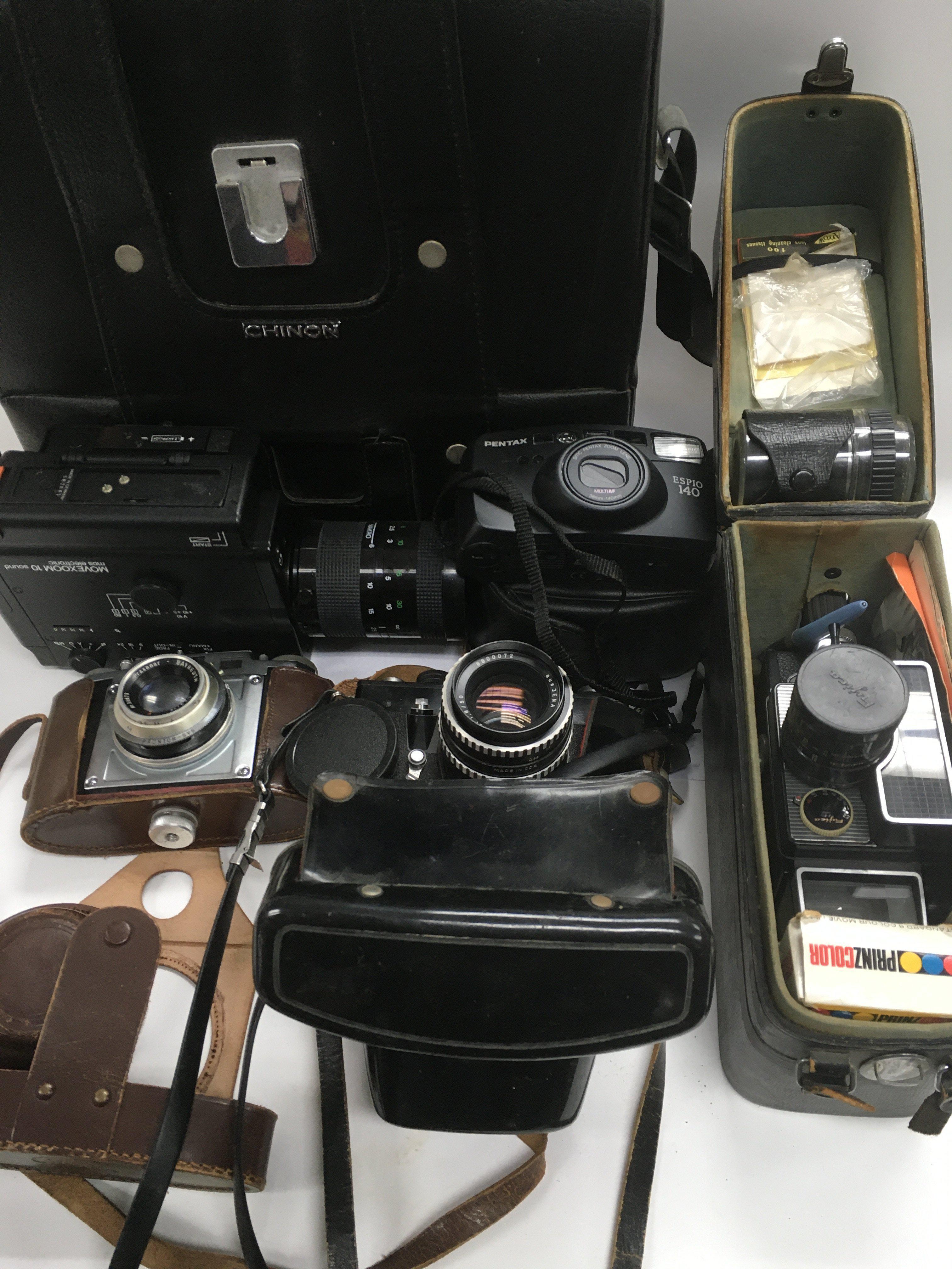 A collection of cameras and film equipment.