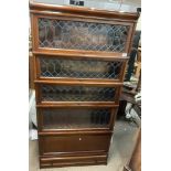 A 1940s four tier Globe-Wernicke bookcase with leaded glass fronts.
