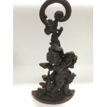 A cast iron door stop decorated with a cherub, app