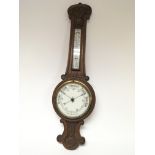 A walnut Aneroid barometer. With a white enamel di