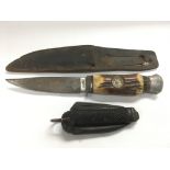 A Solingen hunting knife inset with a compass together with a folding rig knife (2).