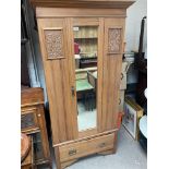 An Edwardian single door wardrobe.