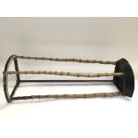 An unusual small stick stand of iron and cane.