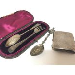 A cased presentation silver spoon and folk, a Silver cigarette case and a silver spoon (3)