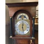 A modern Mahogany long-case clock with visible weights the dial with moon phase