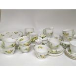 A collection of Primrose patterned bone china and porcelain tea ware including a Shelley sets