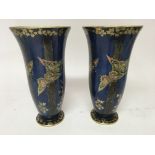 A pair of crown Devon Fieldings vases decorated with butterflies on a blue glazed ground. 25 cm