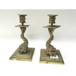 A pair of late Victorian brass candle sticks in th