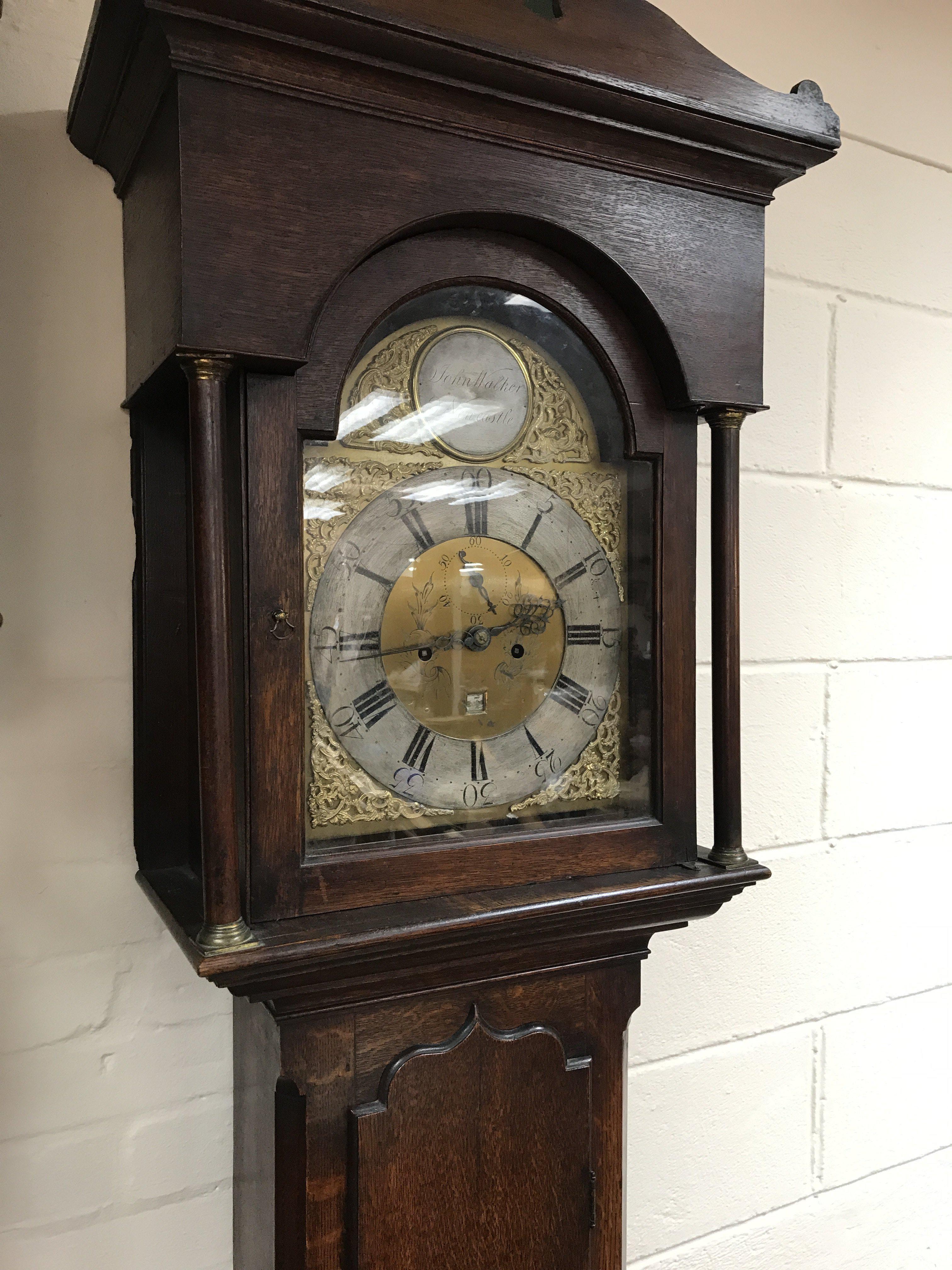 An oak case eight day long case clock the arched d