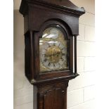 An oak case eight day long case clock the arched d