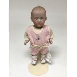 A Gebruder Heubach pouty doll. The markings on the reverse are 3/0.