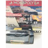 A Boxed Nikko Radio Controlled Thunder Road Lorry 1/25 Scale. A Monopoly Board Game and a Maisto