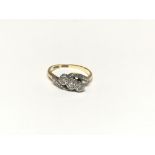 An 18ct gold ladies ring set with three small diam