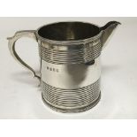 A silver jug with ring turned decoration London ha