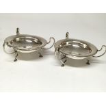 A pair of circular Arts and Crafts silver dishes.