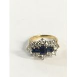 An 18c gold ring set with three sapphires and diam