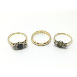 Three gold rings comprising a wedding band and two