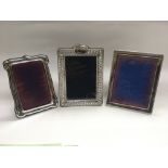 Three silver framed photo frames.