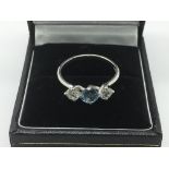 An 18ct white gold ring set with two diamonds and an aquamarine, approx size L-M and approx 3g.