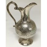 A Sheffield hallmarked engraved silver jug. The ap