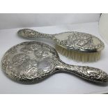 A silver backed dressing mirror and matching brush