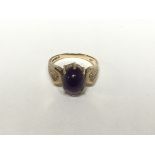 A 9ct gold ring set with an amethyst cabochon, the