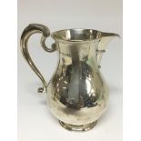 A silver Mappin and Webb sparrow beak jug. The app