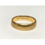 A 22ct gold wedding band, the approximate ring siz