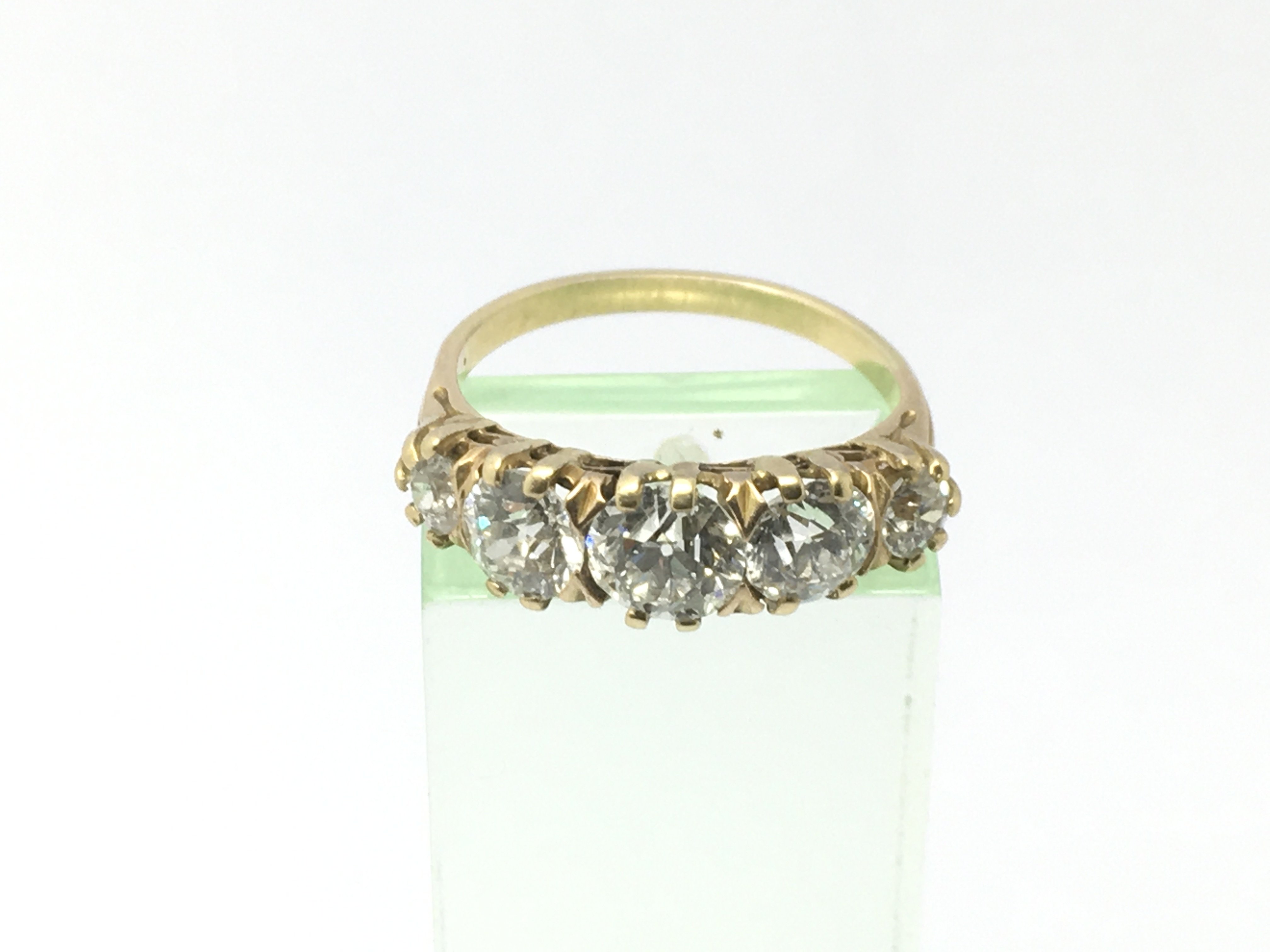 A certificated 9ct gold ring set with five diamond