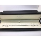 An 18ct white gold diamond line bracelet set with