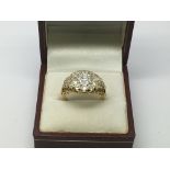 An 18ct gold diamond cluster ring set with a centr