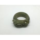 A carved jade ring depicting a mythical beast, app