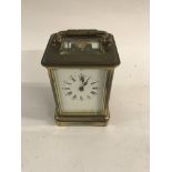 A brass cased carriage clock the dial with Roman n