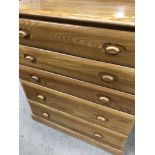 An Ercol style chest of drawers fitted with five d