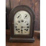 An arch topped mahogany cased alarm clock.