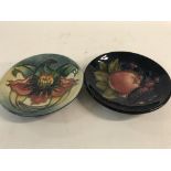 Two moorcroft pin dishes decorated with flowers an