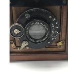 A small mahogany brass bound quarter plate camera