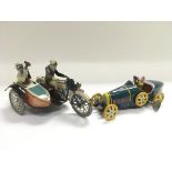 Two reproduction tin plate clockwork vehicles comp
