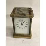 A brass case carriage clock the enamel dial with R