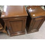 Two walnut single door cabinets on plinth base.